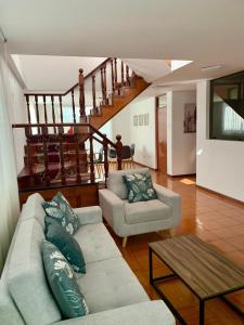 a living room with a couch and a table at Yanahuara Habitacion Acogedora in Yanahuara