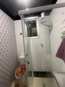 a bathroom with a toilet and a glass shower at Apto na avenida atlântica in Balneário Camboriú +23 photos