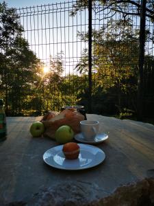 a table with two plates of food and a cup of coffee at Krasen Kras 104 resort in Komen +17 photos