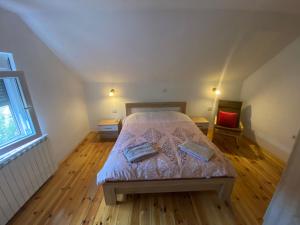a small bedroom with a bed in a attic at Holiday Home Ciara in Kolašin