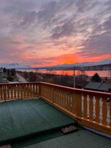 a view of a sunset from the balcony of a house at Top floor apartment with amazing view and location in Tromsø