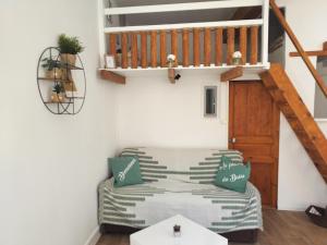 a living room with a couch and a staircase at Au pied du Baou in Saint-Chamas