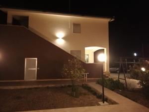 a house at night with lights on the side of it at A Casa Mia in Butera