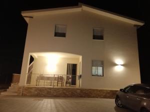 a house at night with a car parked in front at A Casa Mia in Butera