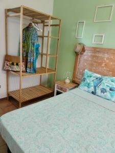 a bedroom with a bed and a clothes rack at A Casa Mia in Butera