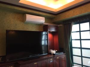 a large flat screen tv in a living room at Hotel Salle de bain (Adult Only) in Osaka