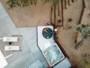 an overhead view of a swimming pool with a palm tree at Villa Paloma By The Cohost Company in Yucca Valley