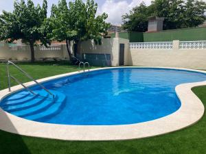 a large swimming pool in a yard with grass at Stunning apartment in Oropesa del Mar in Oropesa del Mar