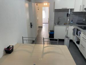 a kitchen with a table and chairs and a sink at T2 N3 Hyper-centre climatisé parking in Albi