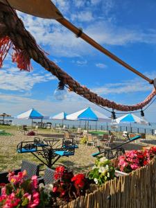 a group of chairs and umbrellas on a beach at Srebrna Riwiera Kadyny in Kadyny