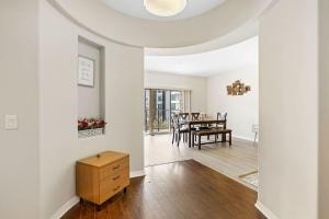 a living room with white walls and a table at Charming 2BR2BA Home Near Downtown LA And Walkable Amenities in Monterey Park