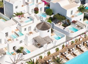 an aerial view of a white building with a pool at Nikki Beach Resort & Spa Santorini in Kamari