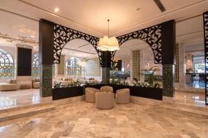 a lobby of a hotel with chairs and a chandelier at One Resort Premium Hammamet in Hammamet Nord