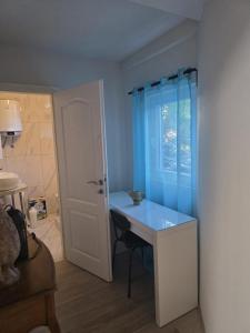 a room with a blue desk and a window at Amelie & Sea - Ground Floor Penthouse with 2 Terraces, Green Views, Sleeps 9 in Vir