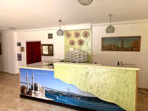 a exhibit in a museum with a large mural of a building at Hotel Istanbul in Skopje