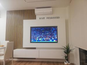 a living room with a tv on a wall at Rest Pedrouzo in O Pedrouzo
