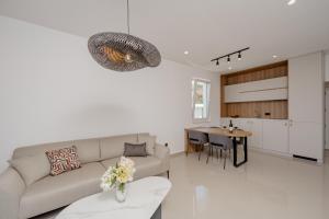 a living room with a couch and a table at Bliss Apartments in Sutomore