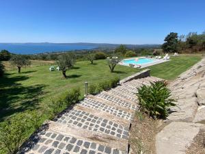 a set of stone steps leading to a swimming pool at Agriturismo Belvedere in Bolsena