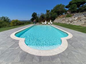 a swimming pool with chairs and a blue at Agriturismo Belvedere in Bolsena +8 photos