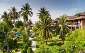 an aerial view of a resort with palm trees at Maehaad Bay Resort - SHA Plus in Mae Haad