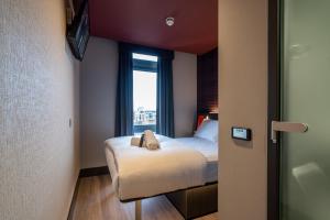 una piccola camera da letto con un letto e una finestra di easyHotel Dublin a Dublino