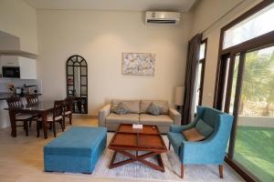 a living room with a couch and chairs and a table at Luxury Hawana Villa in Salalah