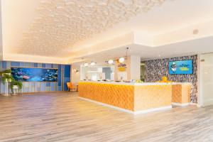 a lobby of a fast food restaurant with a yellow counter at HOVIMA La Pinta Beachfront Family Hotel in Adeje