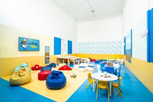 a classroom with chairs and tables and a table and chairs at HOVIMA La Pinta Beachfront Family Hotel in Adeje