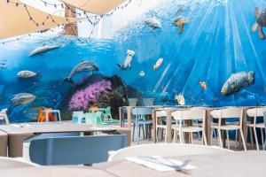 a restaurant with a large aquarium on the wall at HOVIMA La Pinta Beachfront Family Hotel in Adeje