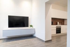 a living room with a tv on a white wall at Tra il Borgo e il Lago in Lovere