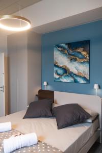 a bedroom with a bed and a painting on the wall at Tra il Borgo e il Lago in Lovere