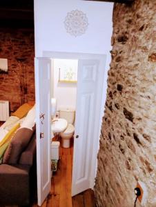 a bathroom with a sink and a toilet in a room at El Petit Paradís in Bellestar