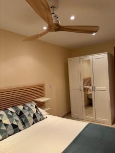 a bedroom with a ceiling fan and a bed at Holiday Paraiso in Sant Antoni de Calonge