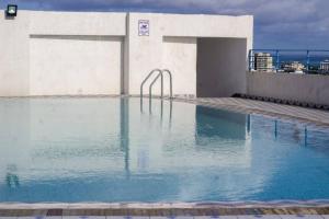 a swimming pool on the roof of a building at Seaview Penthouse, AC included & Rooftop Pool in Mombasa