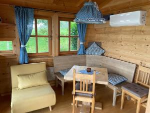 a dining room in a log cabin with a table and chairs at Berghütte am Grandsberg in Schwarzach