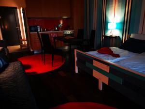 a bedroom with a bed and a table and chairs at Balatonlelle Yacht Club A I15 in Balatonlelle +19 photos