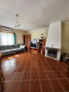 a living room with a couch and a fireplace at Solar Rubina - Piscina Água Salgada in Belmonte