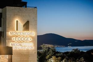 a sign for a hotel with a view of the water at Montenegro Lodge in Tivat