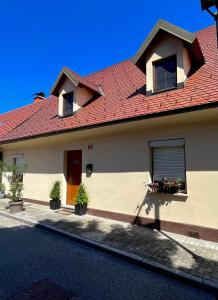 a house with a red roof and a window at Apartma Gasa in Brežice