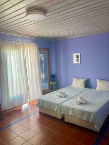 Postel nebo postele na pokoji v ubytování Papa Nero Beach House