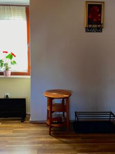 a room with a wooden table and a window at Apartma Gasa in Brežice
