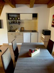 a kitchen with a table with chairs and a box on it at Apartma Gasa in Brežice