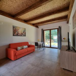 a living room with a red couch and a table at Villapiana Country House in Pellezzano