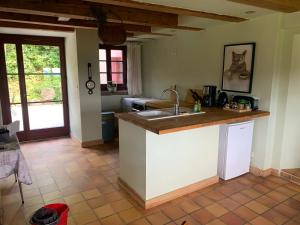 a kitchen with a sink and a counter top at Pour les amoureux de ballades dans les Vosges - 4 nuits minimum in Bertrimoutier