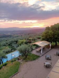 a patio with tables and a tent and a pool at Agriturismo Cafaggio Primo in Loro Ciuffenna