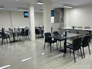 a dining room with tables and chairs in a building at Villa Paradise in Gonio +87 photos