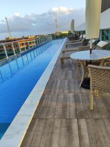 a pool on the roof of a building at Flat Nixxus Porto de Galinhas Ipojuca in Porto De Galinhas +4 photos