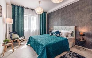 a bedroom with a green bed and a chair at 4 Bedroom Gorgeous Apartment In Medulin in Medulin +33 photos