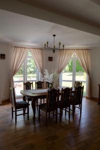 a dining room with a table and chairs at RestHouse - wakacyjny dom nad jeziorem in Wądzyn