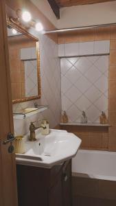 a bathroom with a sink and a mirror and a tub at Το Αρχοντικό του Κάστρου in Kyparissia +27 photos